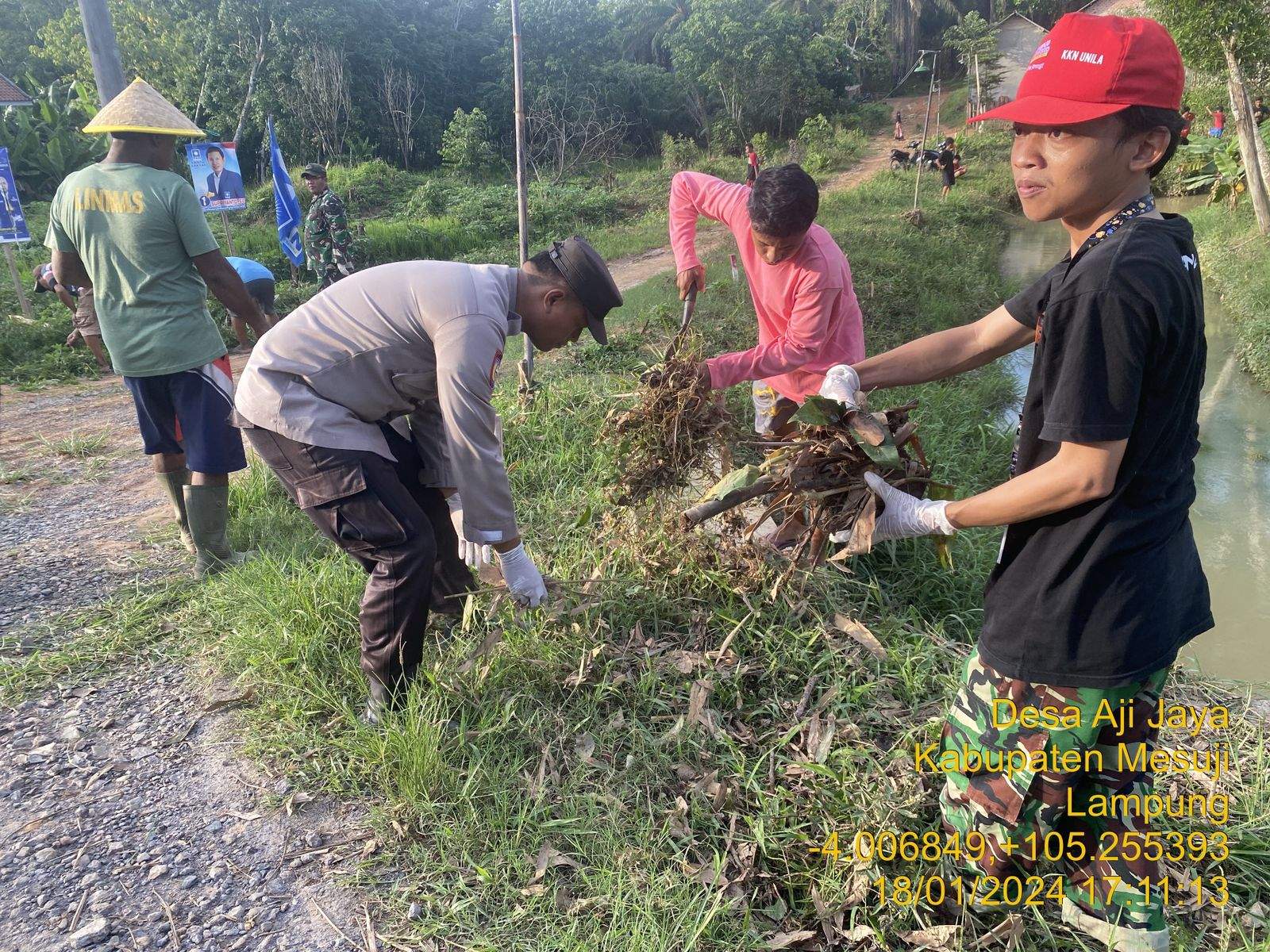 Tanggulangi Musibah Banjir Bhabinkamtibmas Polsek Simpang Pematang Gotong Royong Bersihkan Saluran Air